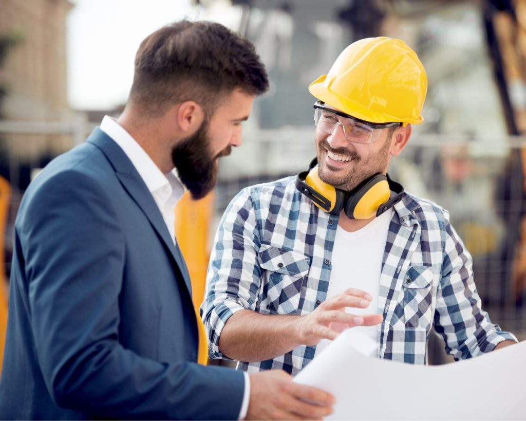 Manufacturing leaders reviewing service plans on a factory floor